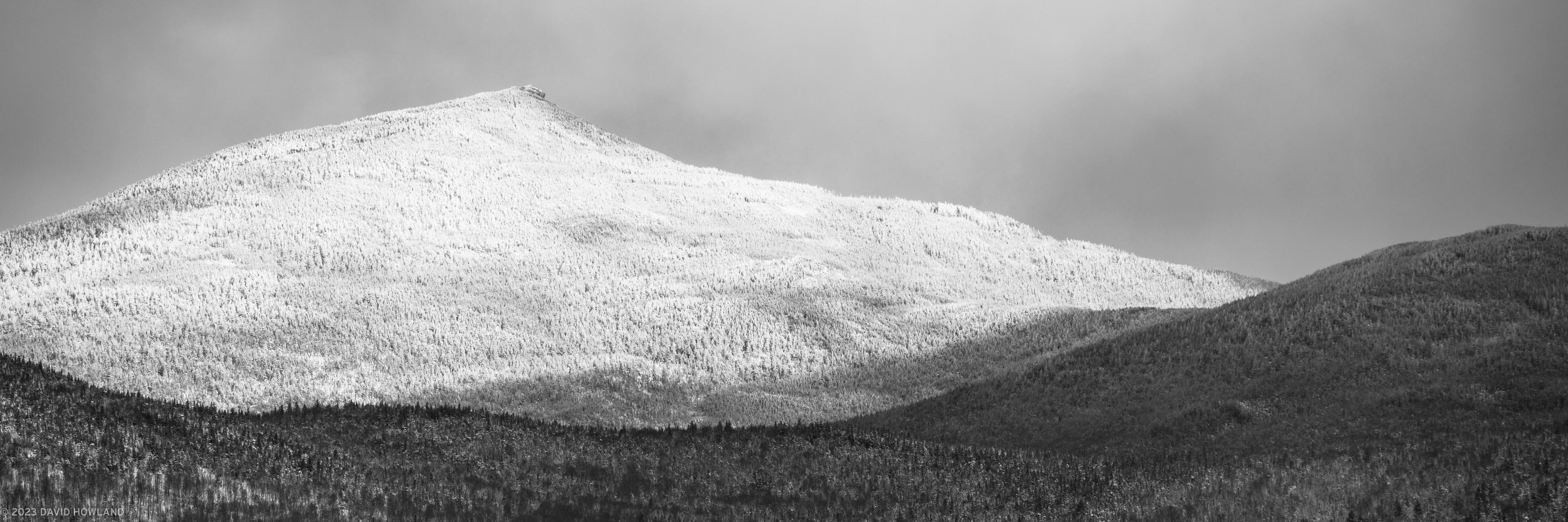 A black and white panorama photo of snow covered trees on the slopes of Mount Garfield in New Hampshire.