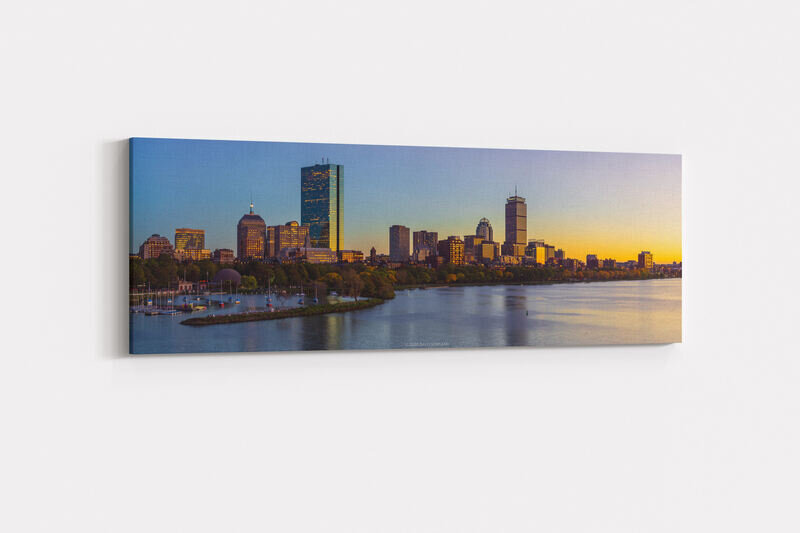 A panorama photo of the illuminated buildings of the Back Bay neighborhood of Boston at sunset.