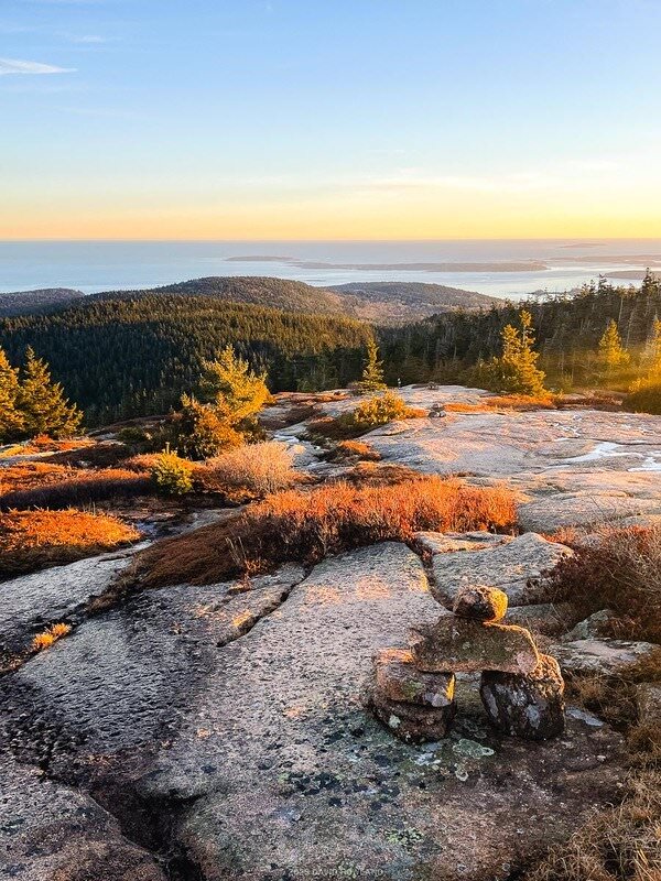 Sunset light over the Atlantic Ocean and the granite Ledges of Pemetic Mountain from the Pemetic South Ridge Trail in Acadia National Park