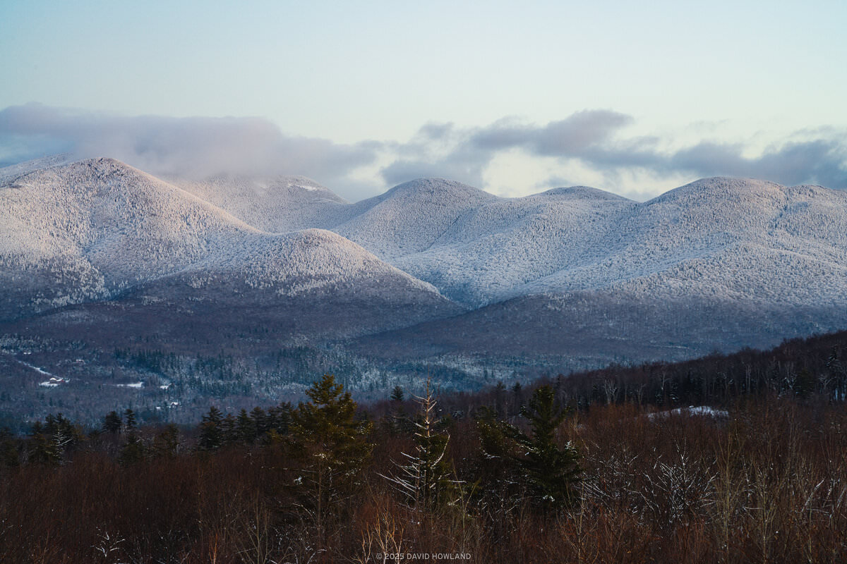 A photo of the snow covered Cannonballs and Cannon Mountain at dusk