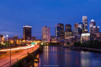 A panorama photo of the Philadelphia skyline and the Schuylkill River taken at sunset from the South Street Bridge