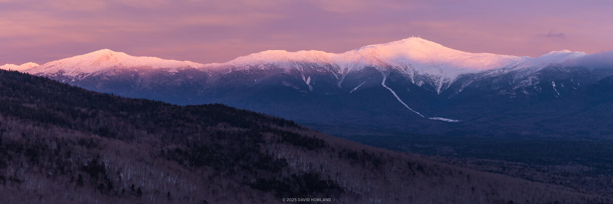 A panorama photo of sunset alpenglow lighting up Mount Monroe, Mount Washington, and Mount Jefferson in the Presidential Range of New Hampshire.