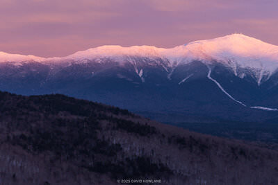A panorama photo of sunset alpenglow lighting up Mount Monroe, Mount Washington, and Mount Jefferson in the Presidential Range of New Hampshire.